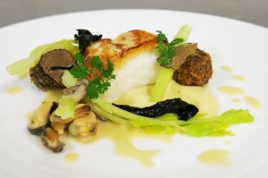 Baked Whitby cod with rope cultured mussels and champagne sauce, artichoke purèe and fresh truffle arancini with celery